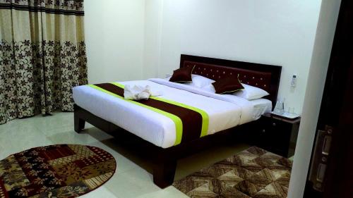 a bedroom with a bed with a stuffed animal on it at A Superior King Room Manyata Tech Park IT Corporate Service Apartment in Bengaluru