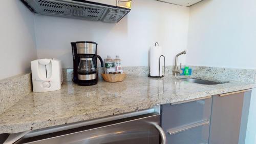 a kitchen with a counter top with a coffee maker at Charming Studio in Boston Brownstone, C. Ave #33 in Boston