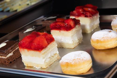 a tray filled with different types of cakes and pastries at HOTEL B&B MARILENA in Arabba