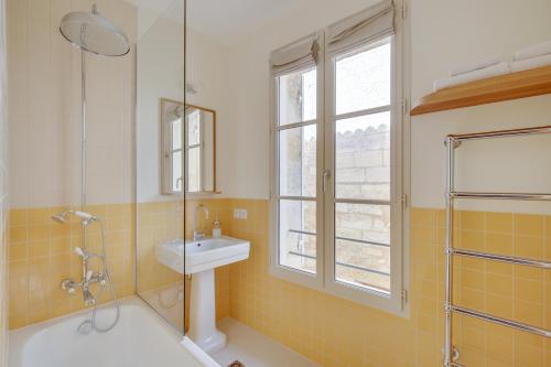 a bathroom with a sink and a shower at Badon Boutique Hotel in Saint-Émilion