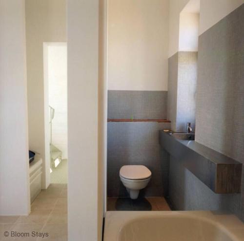 a bathroom with a white toilet and a sink at Coastguard Lookout by Bloom Stays in Littlestone-on-Sea