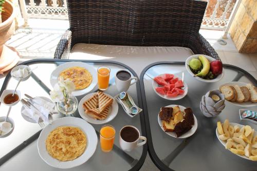 a table with plates of breakfast food on it at Sofotel in Koroni