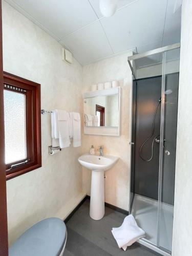 a bathroom with a sink and a shower at Camping Jungfrau in Lauterbrunnen