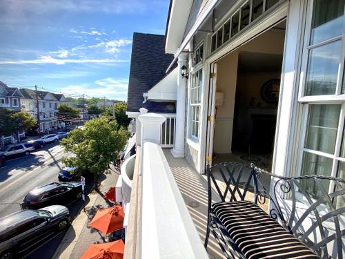 a porch of a house with a bench on it at Inn on Main Hotel in Manasquan
