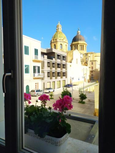 a window with flowers in a pot on a window sill at Slo Design House in Marsala