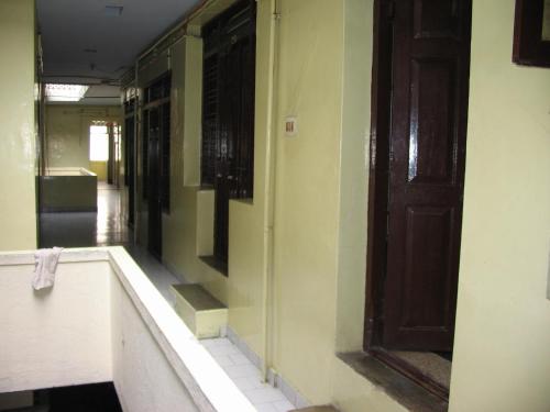 a bathroom with a bath tub and a door at Vasantha Lodge Purasawalkam chennai in Chennai