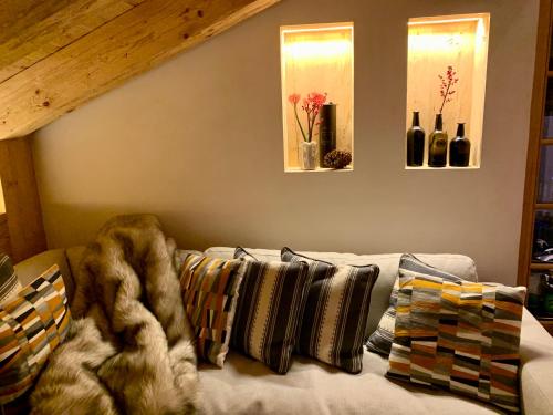 a living room with a couch with pillows at New, Luxurious and Central Art Penthouse in Verbier