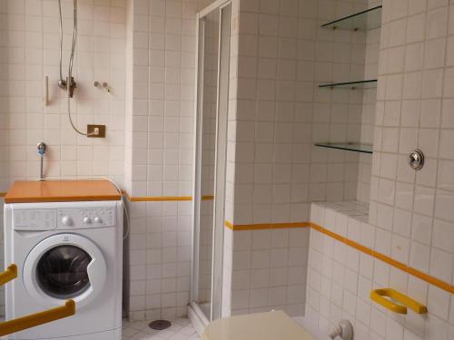 a washing machine in a bathroom with a shower at casa Calla in Maiori
