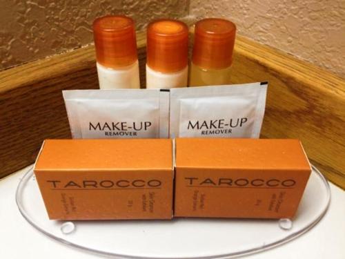 three bottles of taroconoco products sitting on a plate at Flagship Inn & Suites in Groton