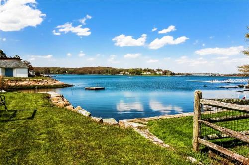 a view of a lake with a fence at Flagship Inn & Suites in Groton
