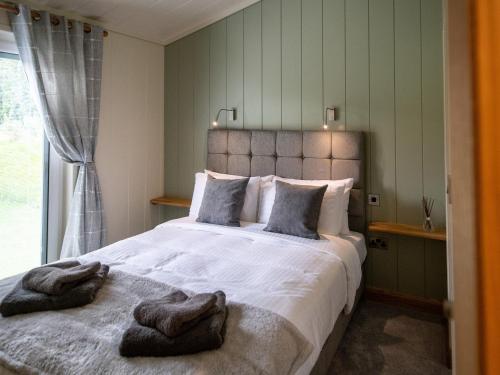 Ένα ή περισσότερα κρεβάτια σε δωμάτιο στο Otter Lodge