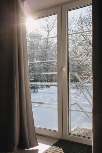 a window with a view of a snow covered yard at Leśniki in Babimost