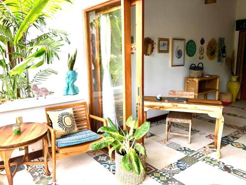 een woonkamer met een tafel, een stoel, een tafel en een tafelblad bij Sriyana Uluwatu in Uluwatu