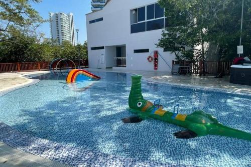a toy dinosaur in the middle of a swimming pool at Samaria Club de Playa! Salida directa al mar! Pozos Colorados, diversión para niños y grandes in Santa Marta