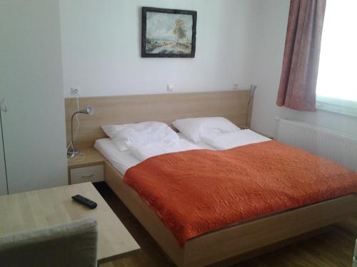 a bedroom with a bed and a table with a lamp at Apartments Benedičič in Bled