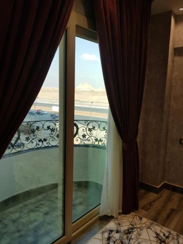 
a view from a window of a beach with a view of the ocean at Pyramids Planet Hotel in Cairo
