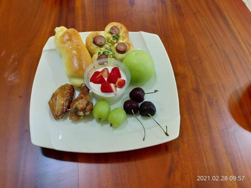 un piatto di alimenti con uve e frutta su un tavolo di 晴川樹 a Città di Taitung