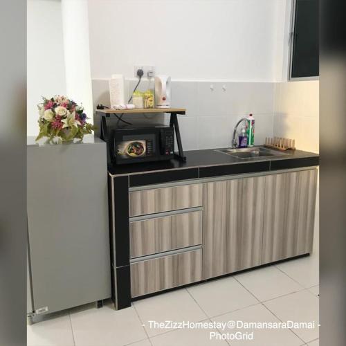 a kitchen with a sink and a microwave at The Zizz Homestay@Damansara Damai in Petaling Jaya