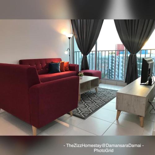 a living room with a red couch and a balcony at The Zizz Homestay@Damansara Damai in Petaling Jaya