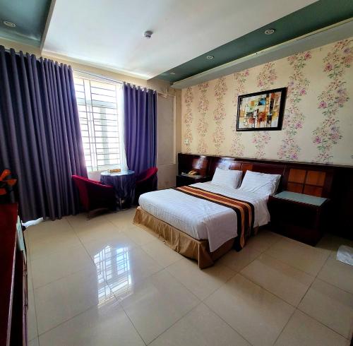 a bedroom with a bed and purple curtains at Hồ Tây Hotel in Thu Dau Mot