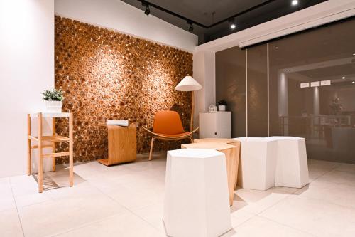 a room with white tables and a wall covered in dots at Hommie Inn in Taichung