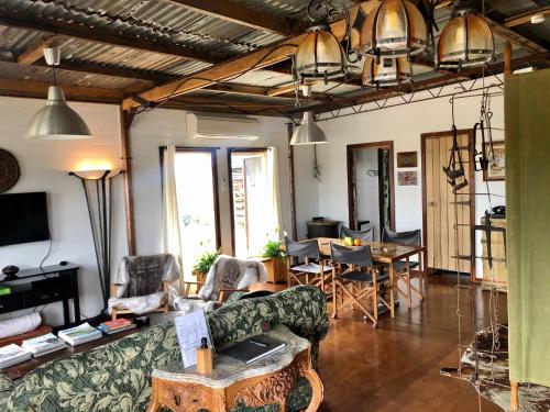 a living room with a couch and a table at Sunset Cottage - Yarra Valley in Healesville