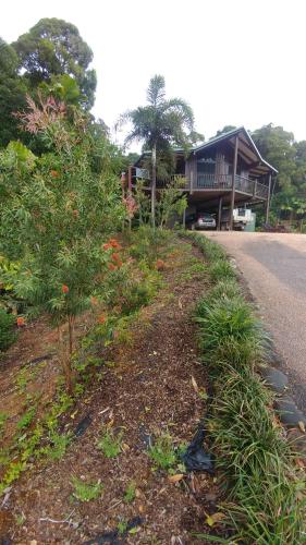 a house sitting on the side of a road at Daintree Holiday Homes - Yurara in Cow Bay