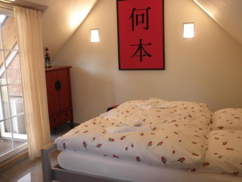 Giường trong phòng chung tại Ferienhaus Kamerun an der Elbe - CASA KAMERUNSCHAF