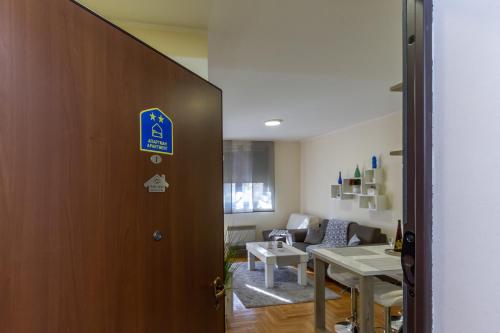 a door leading to a living room with a table at Predo Apart in Zlatibor