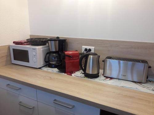 a kitchen counter with a microwave and appliances on it at Appartement 4/6 pers plein sud. Front de neige in Isola 2000