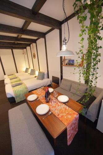 a living room with a table and a bed at JINYA Fujikawaguchiko in Fujikawaguchiko