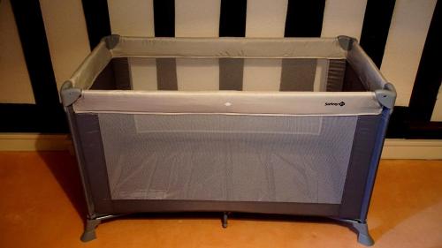 a baby crib with a plastic box in a room at Le Pressoir in Beaumesnil