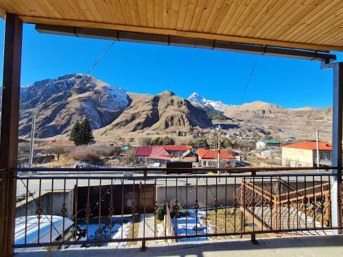 a view of a mountain from a balcony at Sunny Mountain House in Stepantsminda