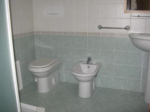 a bathroom with a toilet and a sink at Miramare Isola Rossa in Isola Rossa