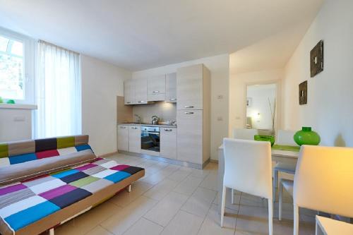 a living room with a table and a kitchen at La Pervinca Apartments in Malcesine