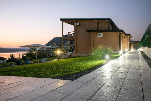 a walkway in front of a house with lights at Шале Рутенія - Chalet Rutenia apartments in Neporotovo