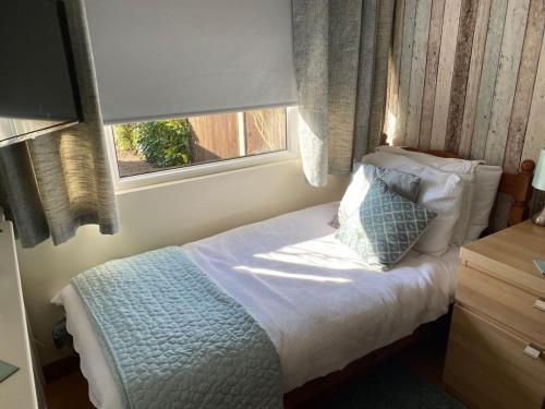 A bed or beds in a room at The Peels B&B 