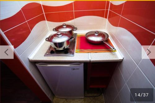 a small kitchen with two pots on a stove at 500 Meters from Grate Beach, App 1 in Ulcinj