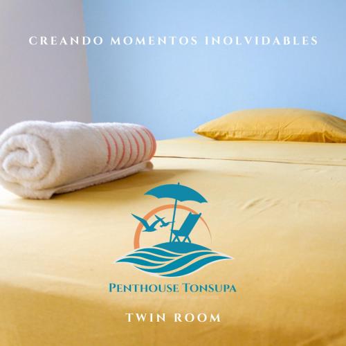 a sign on a bed with an umbrella and a towel at Discoverequador in Tonsupa