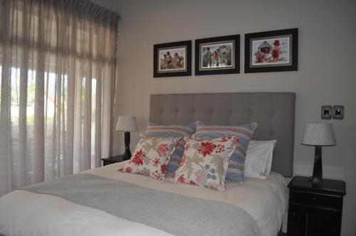a bedroom with a bed with pillows on it at A Perfect Self Catering in Wellington