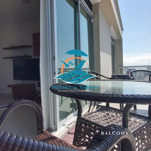 a table with a surfboard on it on a balcony at Discoverequador in Tonsupa