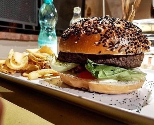 a sandwich and chips on a plate on a table at Bobo’s Home in Iglesias