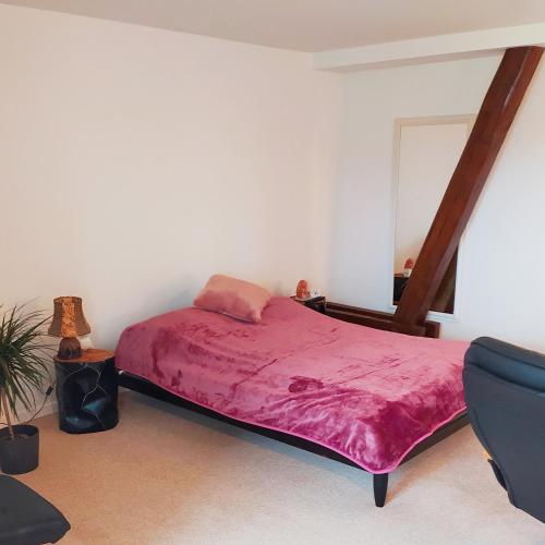 a bedroom with a bed with a red blanket at Studiowohnung in Bergen/Bleckmar in Bergen