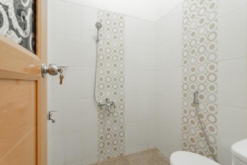 a bathroom with a shower with a toilet at RedDoorz Syariah Plus @ Perintis Guesthouse Tasikmalaya in Tasikmalaya