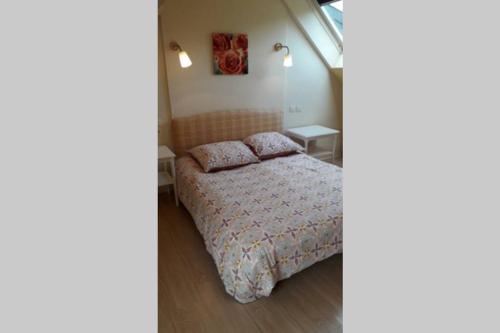 a bedroom with a bed and two night stands at Ti Aval - Gîte de charme à la campagne - côte de granit rose in Bégard