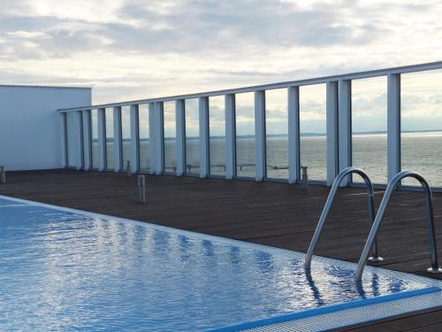 a swimming pool on the balcony of a building at Promenada28pl - Apartamenty z widokiem na morze in Międzyzdroje