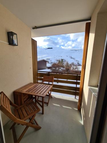balcón con mesa, sillas y vistas al océano en Appartement 4 pers. pied des pistes Les 2 Alpes, en Les Deux Alpes