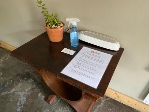 a table with a bottle of water and a phone on it at RElaxed city living in Port Elizabeth