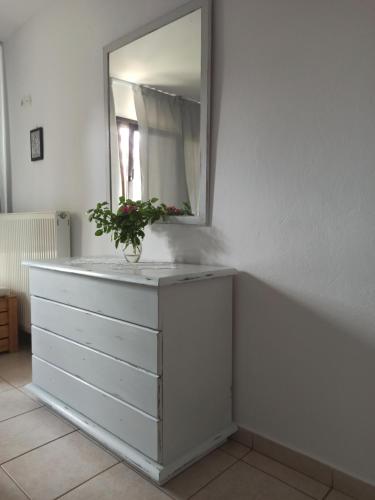a dresser with a mirror on top of it at Dora's House comfortable apartment with a yard and view in Pyrgadikia