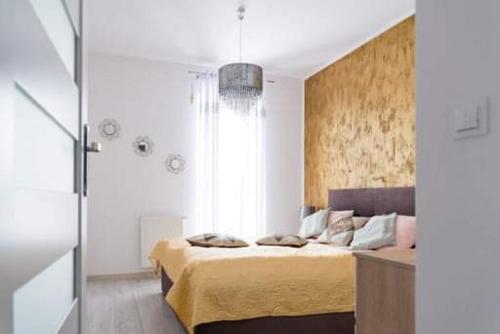 a bedroom with two beds and a large window at APARTAMENT KAMILA in Gdańsk